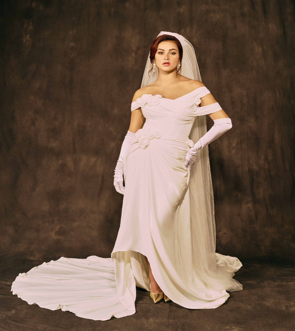Woman in a white wedding dress with a long train and veil 